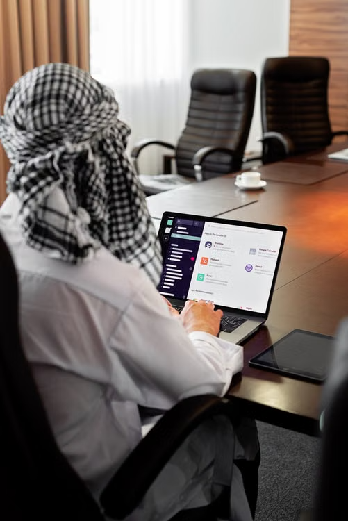Group of coworkers looking down at a computer screen